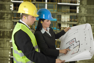 Engineer and client looking on project on the construction site